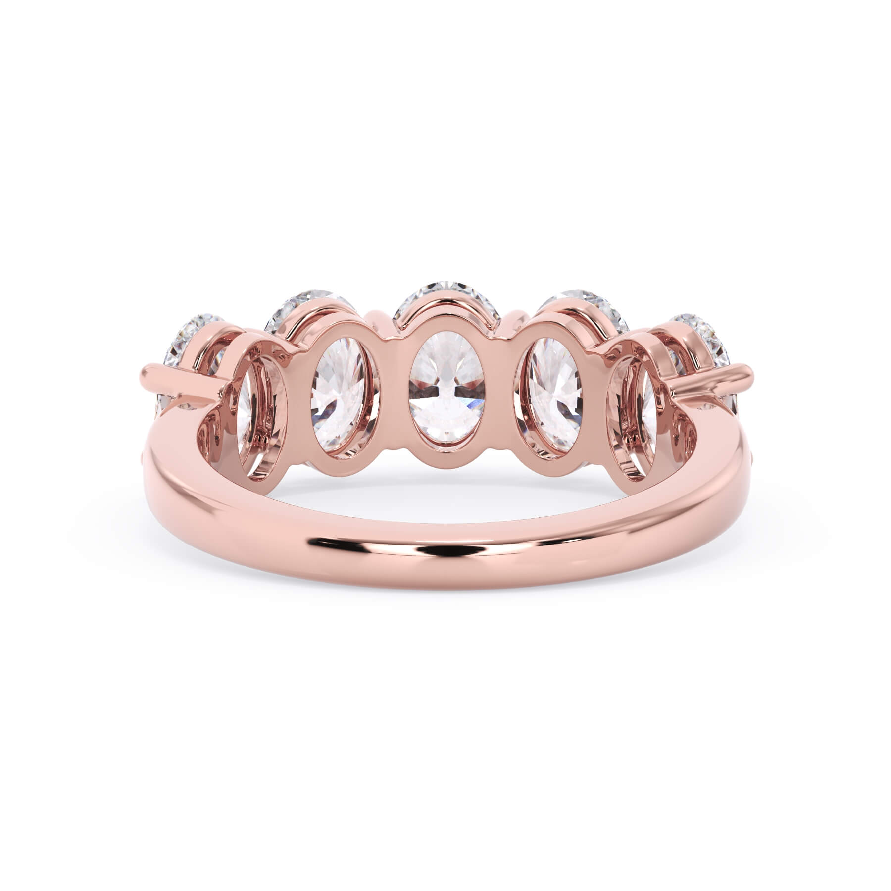 A picture of a five stone diamond wedding ring with oval shape diamonds that are shared prong set in rose gold on a white background with a view of the underside of the ring.