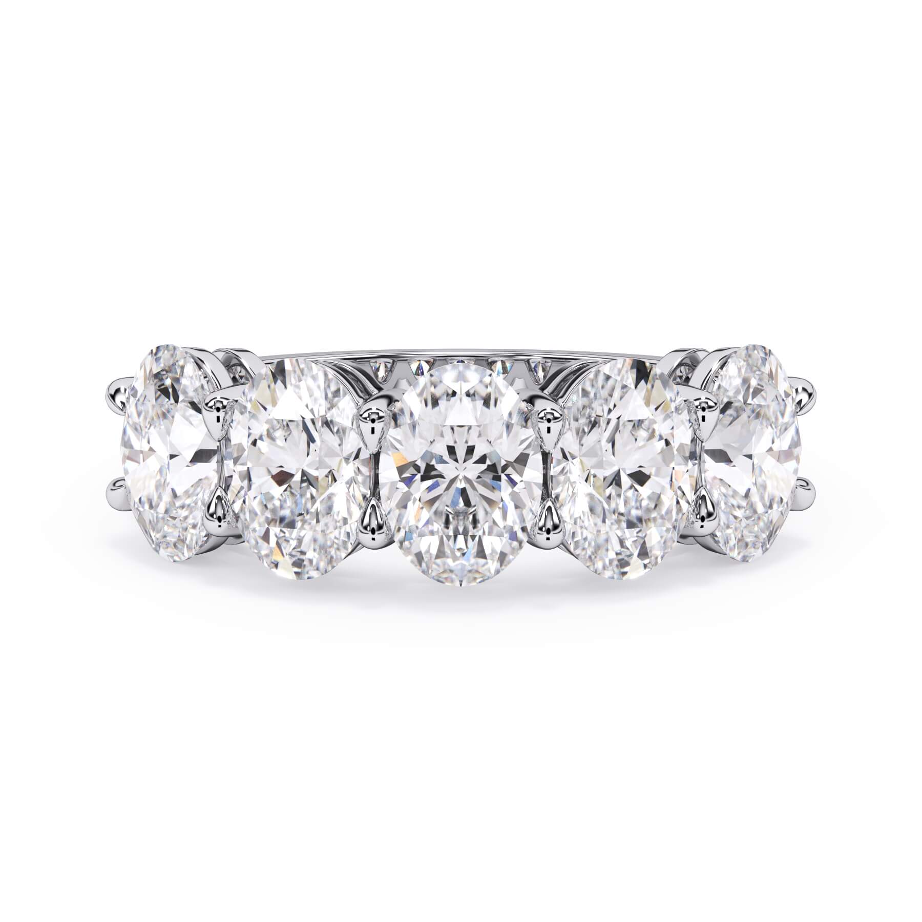 A picture of a five stone diamond wedding ring with oval shape diamonds that are shared prong set in white gold or platinum on a white background with the ring facing forward, lying down.