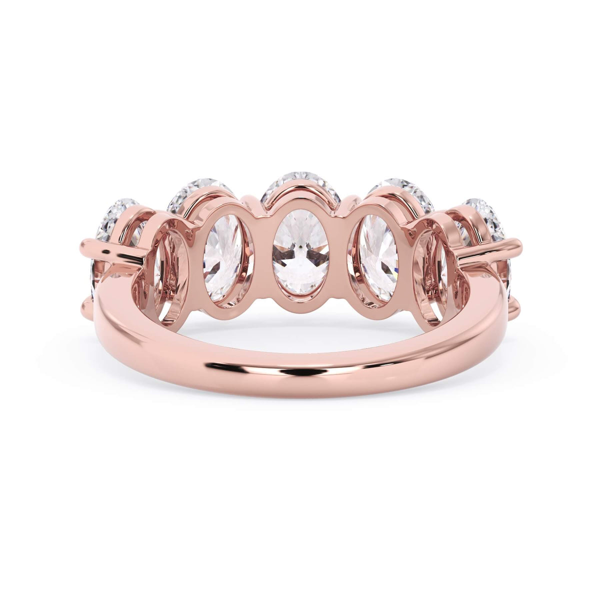A picture of a five stone diamond wedding ring with oval shape diamonds that are shared prong set in rose gold on a white background with a view of the underside of the ring.