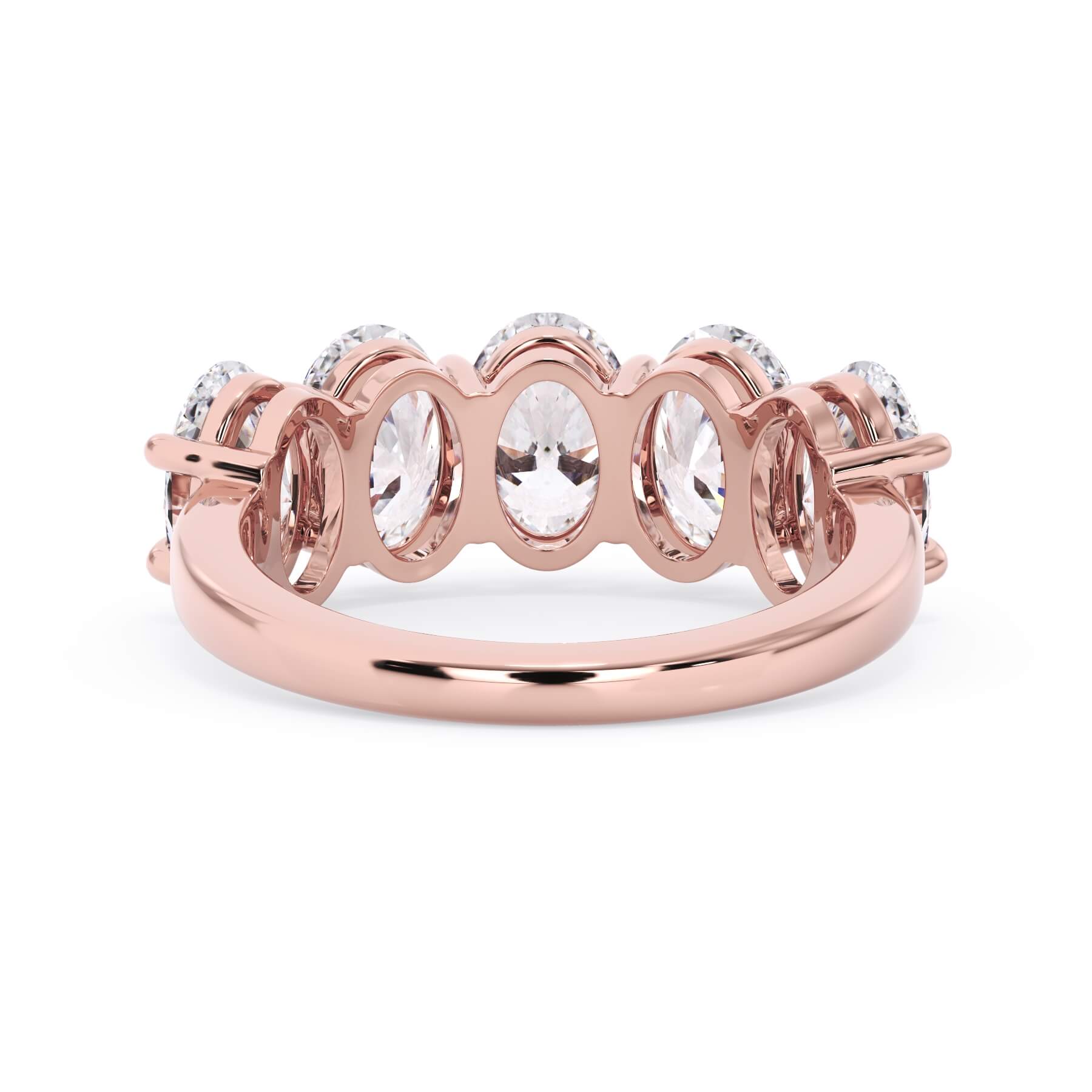 A picture of a five stone diamond wedding ring with oval shape diamonds that are shared prong set in rose gold on a white background with a view of the underside of the ring.