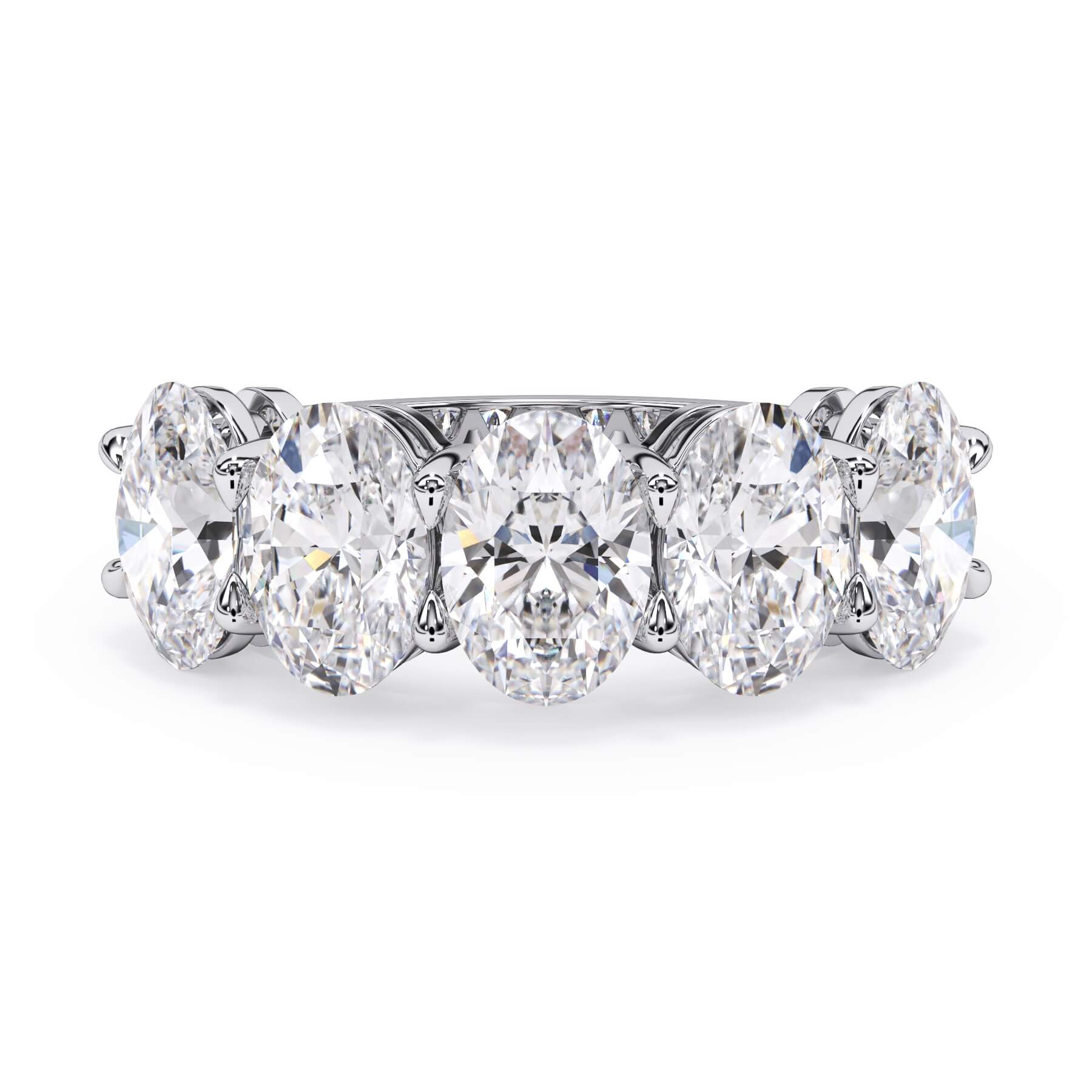 A picture of a five stone diamond wedding ring with oval shape diamonds that are shared prong set in white gold or platinum on a white background with the ring facing forward, lying down.