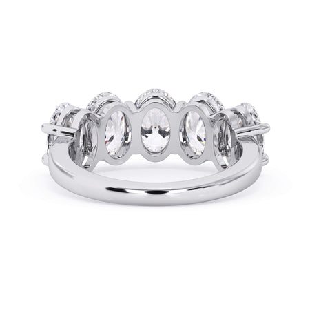 A picture of a five stone diamond wedding ring with oval shape diamonds that are shared prong set in white gold or platinum on a white background with a view of the underside of the ring.