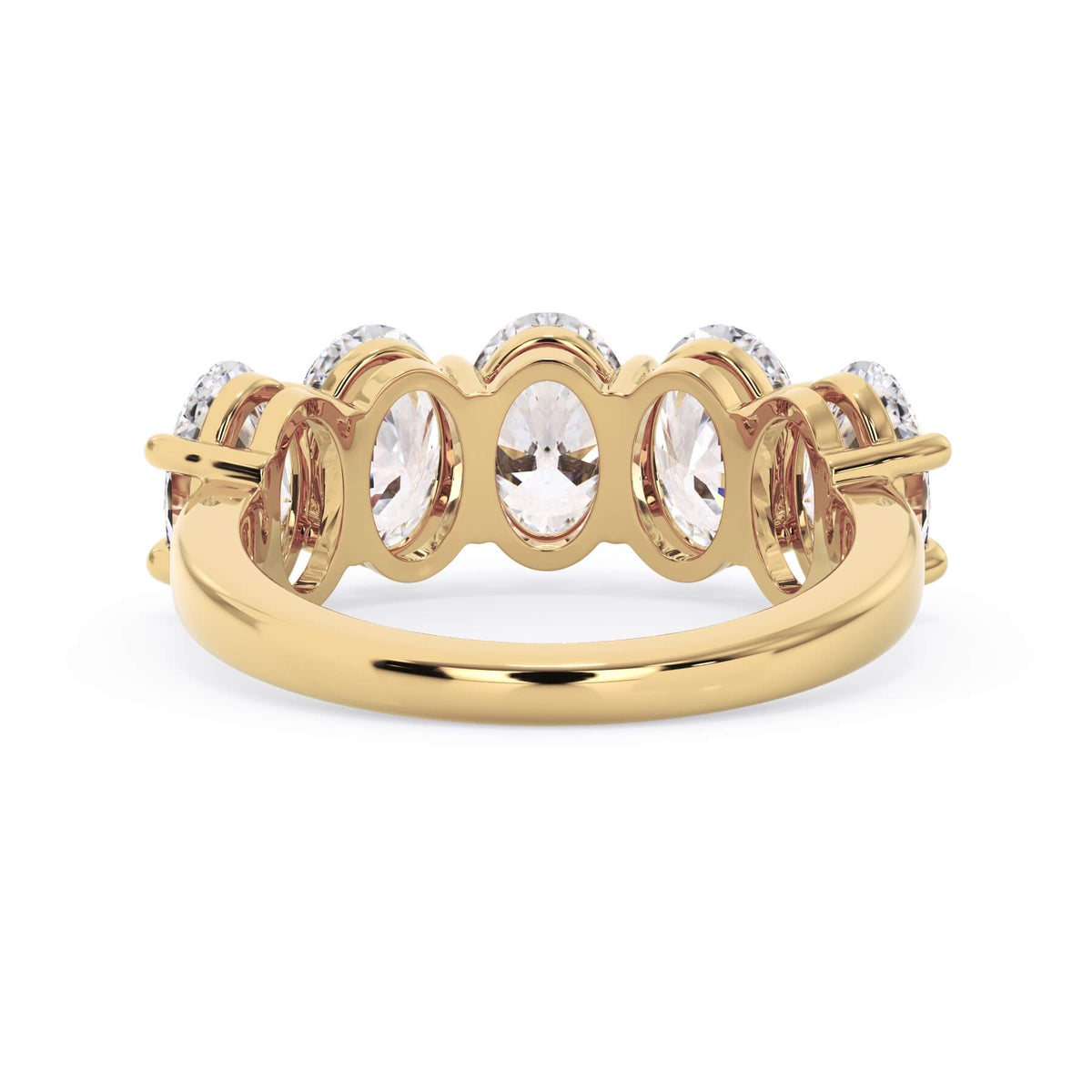 A picture of a five stone diamond wedding ring with oval shape diamonds that are shared prong set in yellow gold on a white background with a view of the underside of the ring.