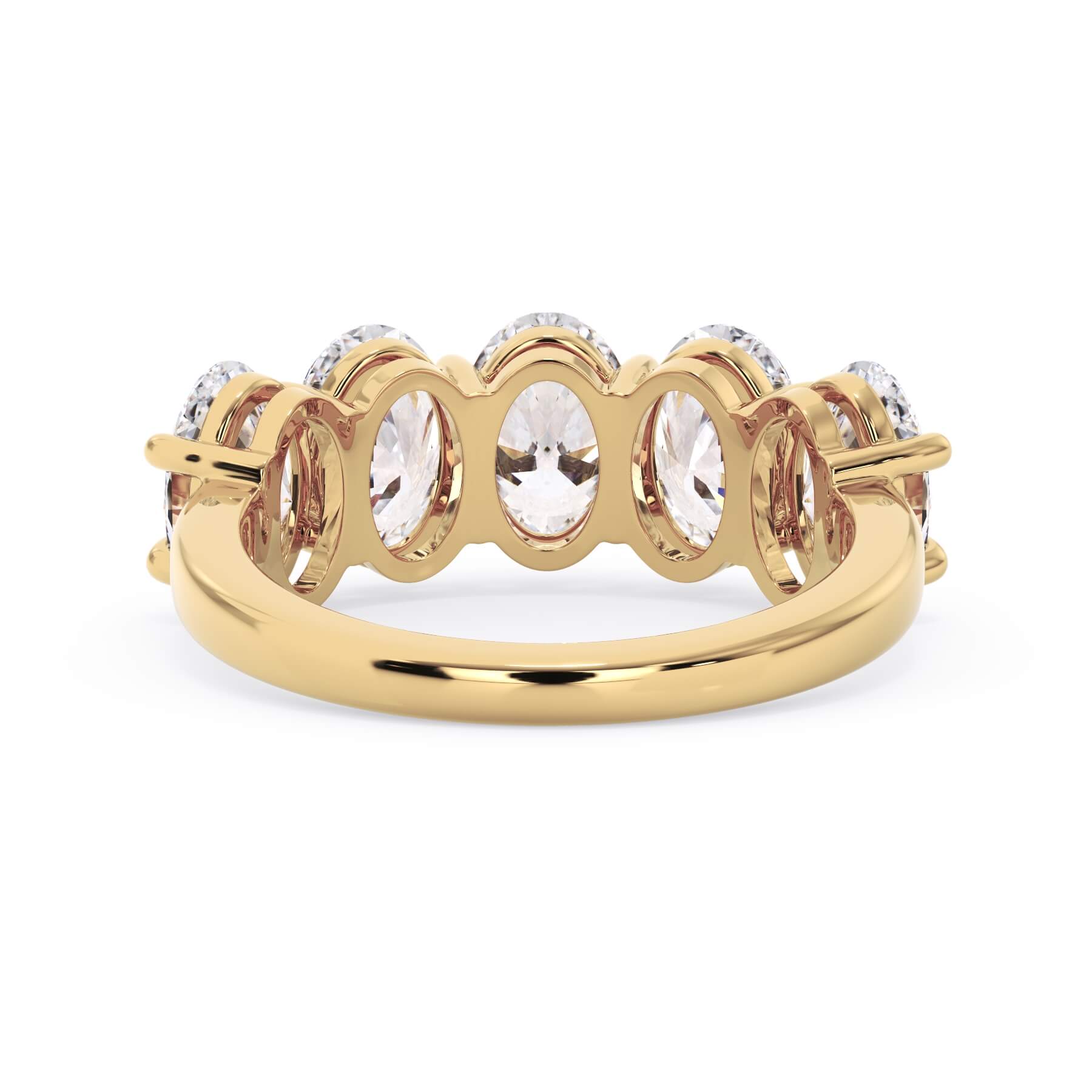 A picture of a five stone diamond wedding ring with oval shape diamonds that are shared prong set in yellow gold on a white background with a view of the underside of the ring.