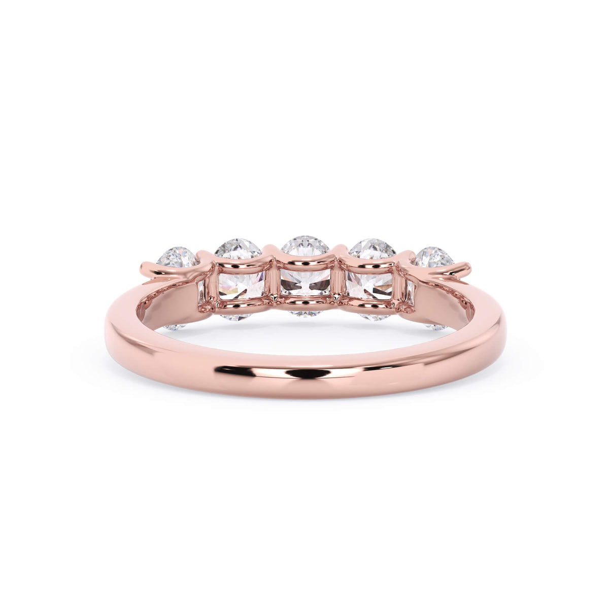 A picture of a five stone diamond wedding ring with oval shape diamonds that are u prong set in rose gold on a white background with a view of the underside of the ring.