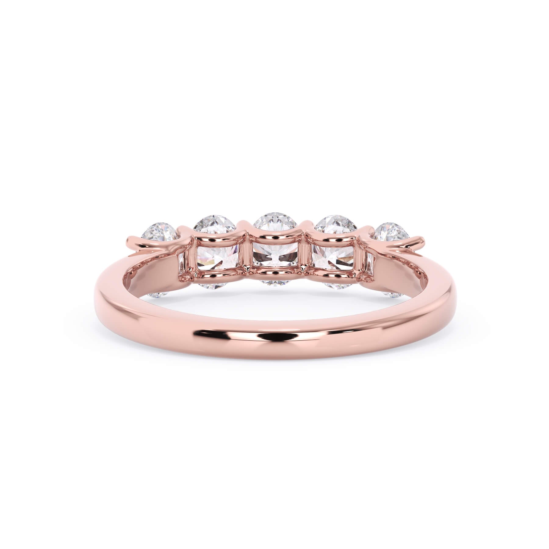 A picture of a five stone diamond wedding ring with oval shape diamonds that are u prong set in rose gold on a white background with a view of the underside of the ring.