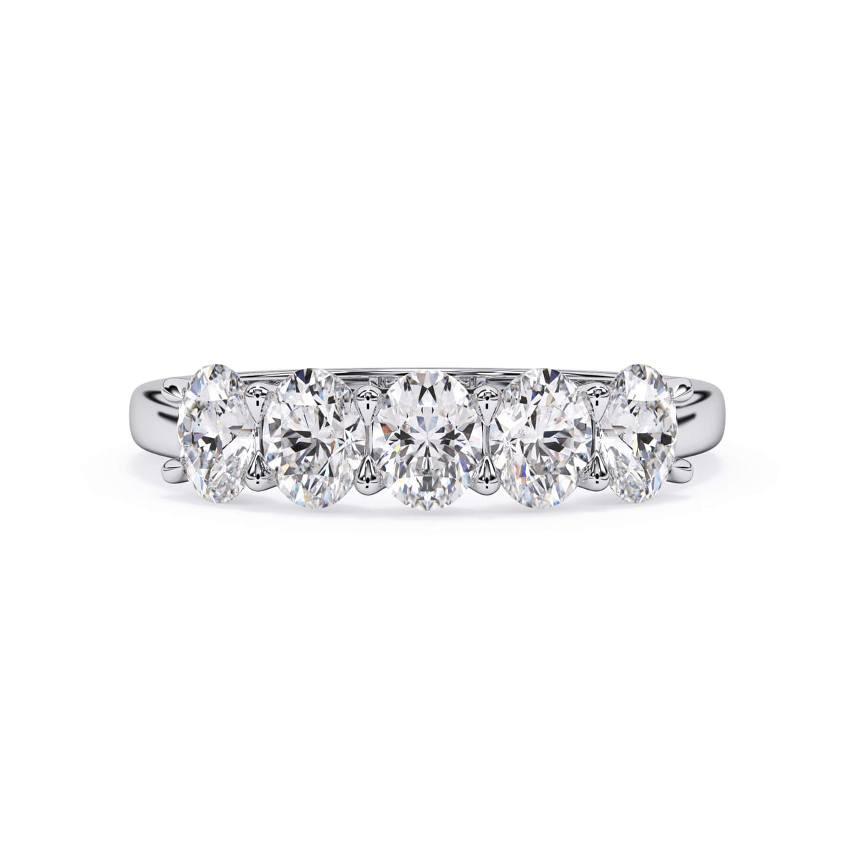 A picture of a five stone diamond wedding ring with oval shape diamonds that are u prong set in white gold or platinum on a white background with the ring facing forward, lying down.