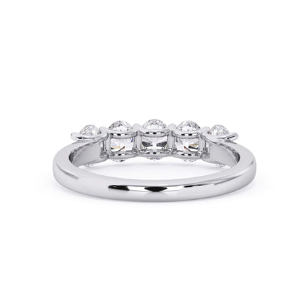 A picture of a five stone diamond wedding ring with oval shape diamonds that are u prong set in white gold or platinum on a white background with a view of the underside of the ring.