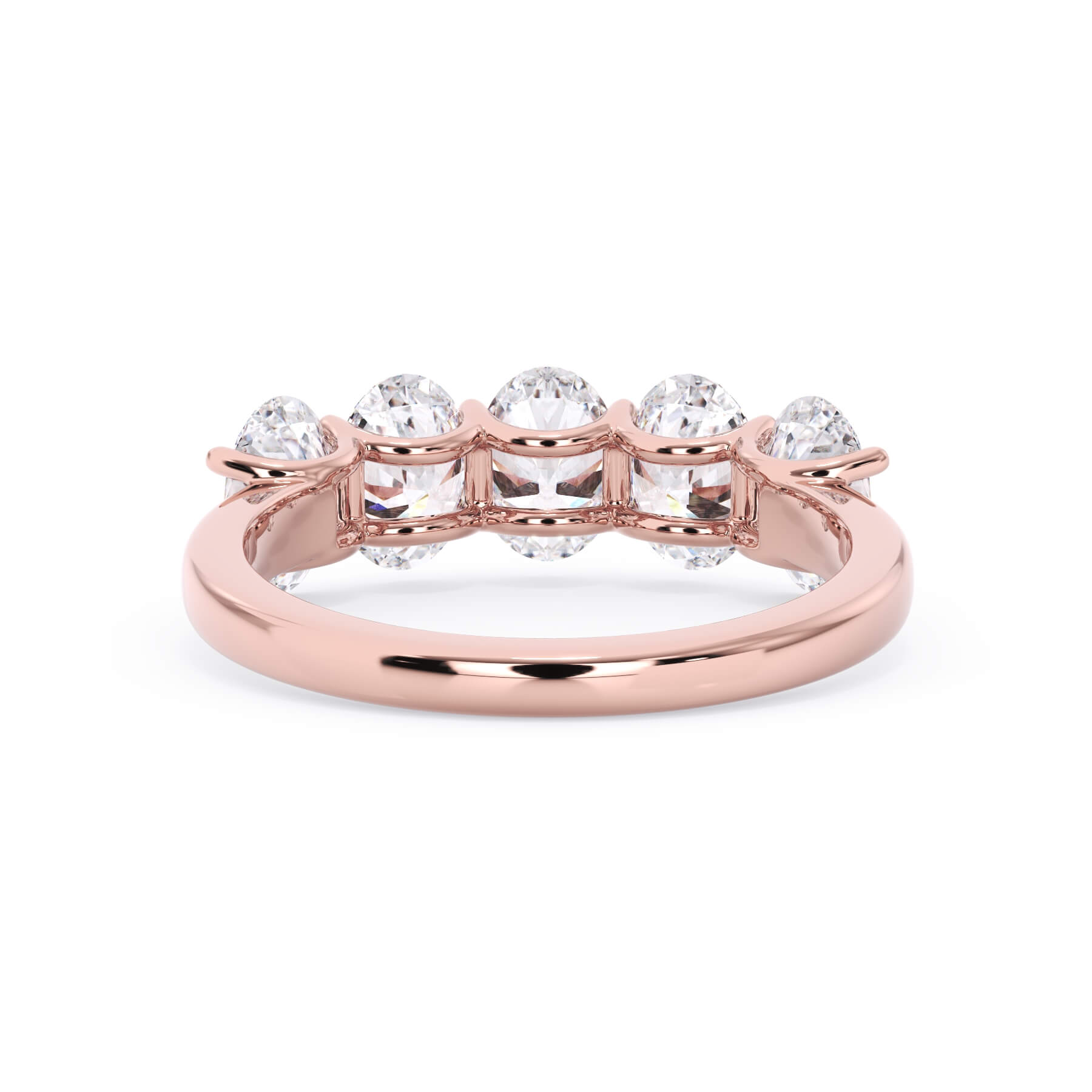 A picture of a five stone diamond wedding ring with oval shape diamonds that are u prong set in rose gold on a white background with a view of the underside of the ring.