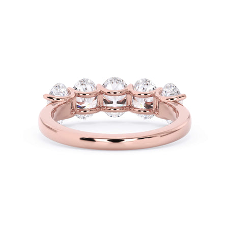 A picture of a five stone diamond wedding ring with oval shape diamonds that are u prong set in rose gold on a white background with a view of the underside of the ring.