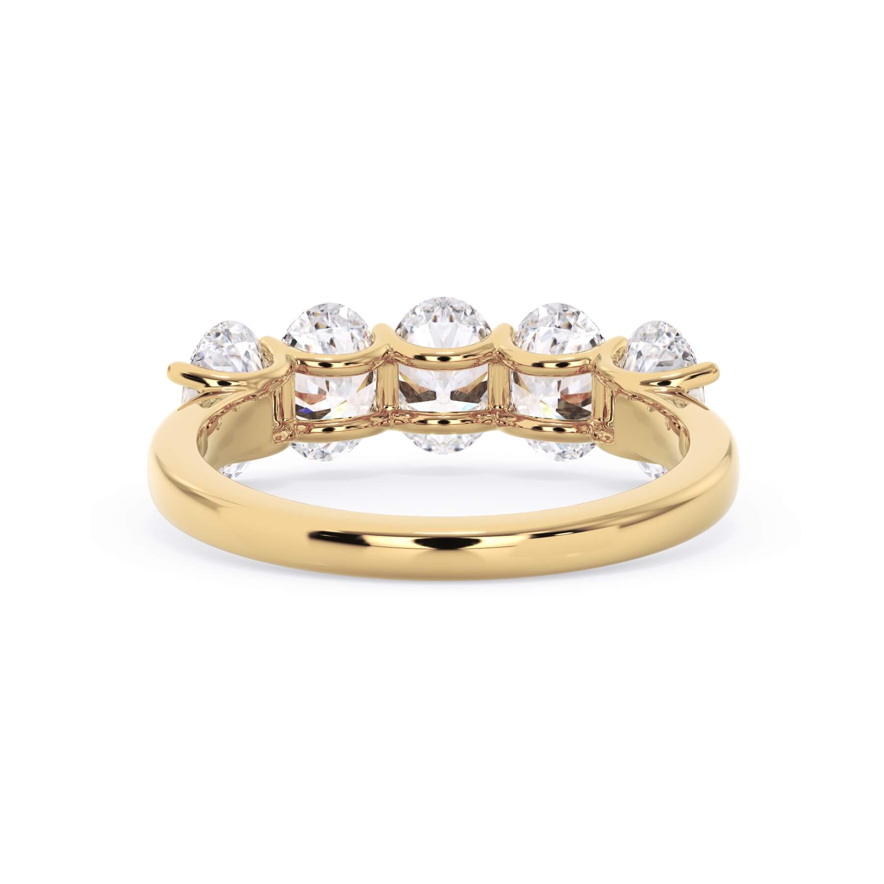 A picture of a five stone diamond wedding ring with oval shape diamonds that are u prong set in yellow gold on a white background with a view of the underside of the ring.