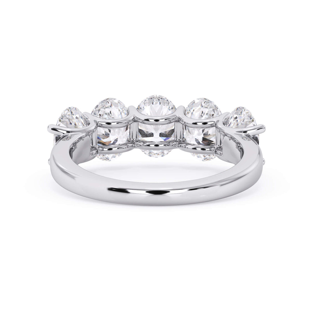 A picture of a five stone diamond wedding ring with oval shape diamonds that are u prong set in white gold or platinum on a white background with a view of the underside of the ring.
