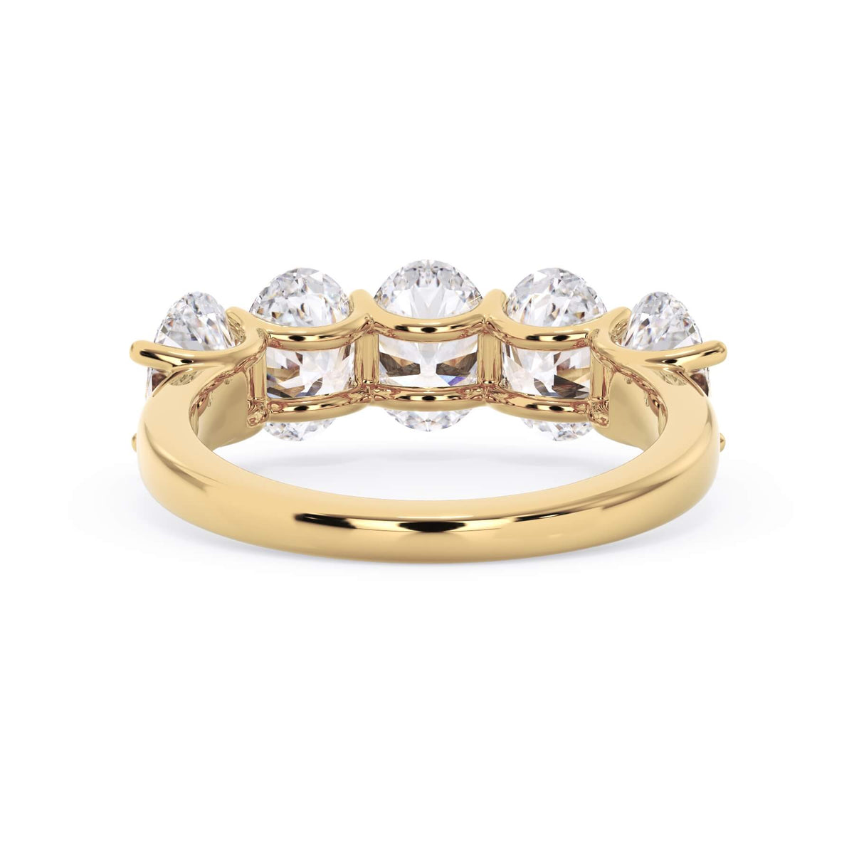 A picture of a five stone diamond wedding ring with oval shape diamonds that are u prong set in yellow gold on a white background with a view of the underside of the ring.