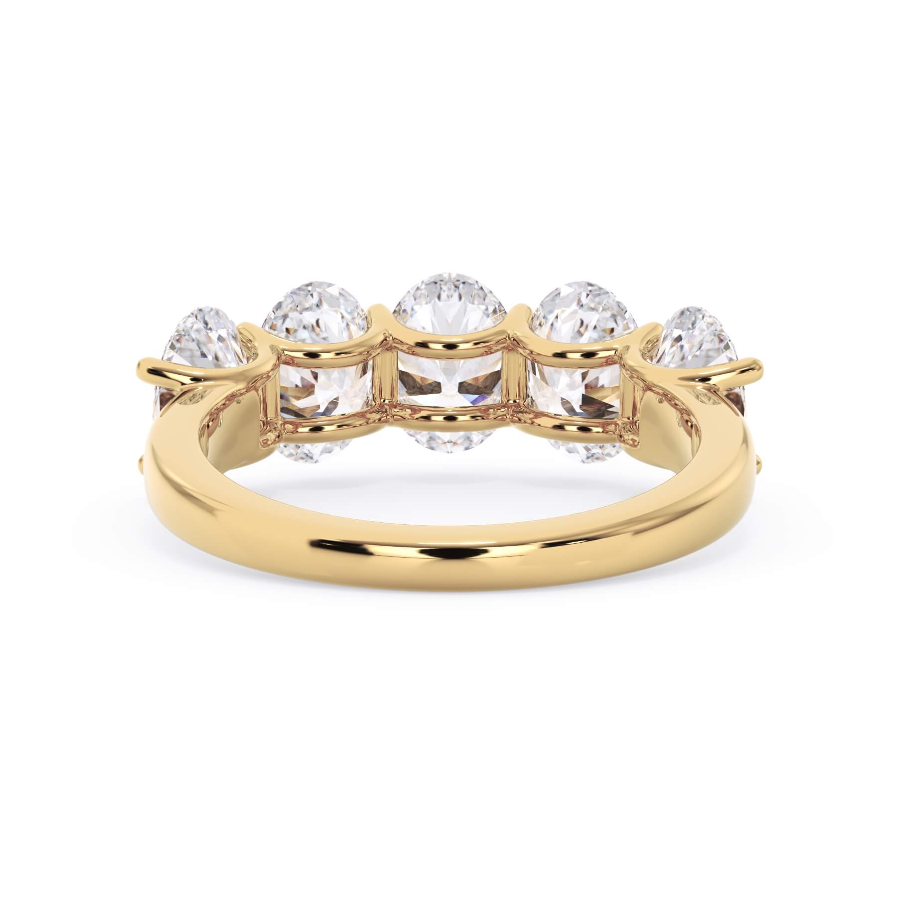 A picture of a five stone diamond wedding ring with oval shape diamonds that are u prong set in yellow gold on a white background with a view of the underside of the ring.