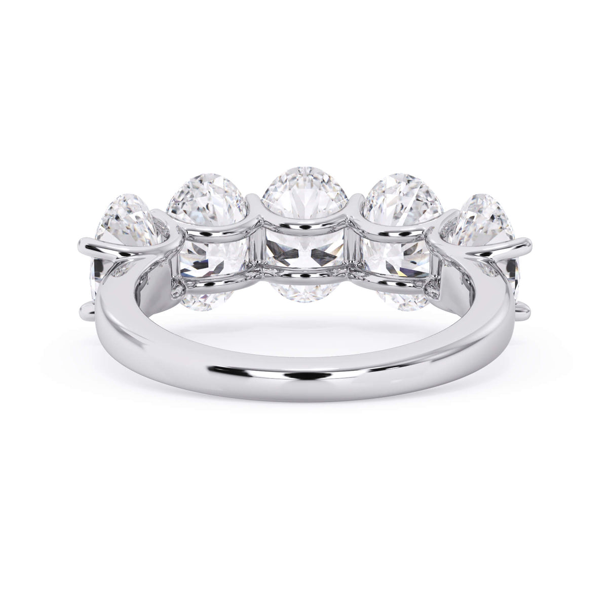 A picture of a five stone diamond wedding ring with oval shape diamonds that are u prong set in white gold or platinum on a white background with a view of the underside of the ring.