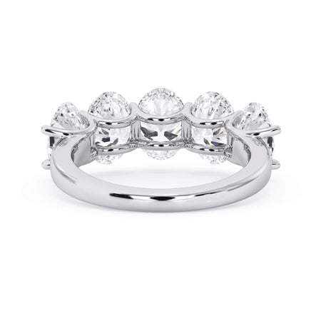 A picture of a five stone diamond wedding ring with oval shape diamonds that are u prong set in white gold or platinum on a white background with a view of the underside of the ring.