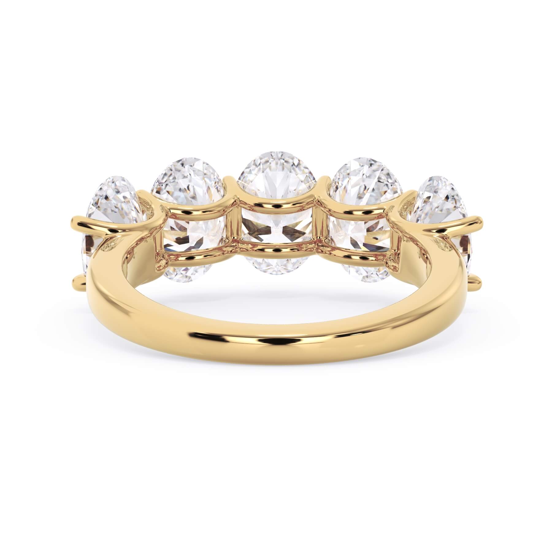 A picture of a five stone diamond wedding ring with oval shape diamonds that are u prong set in yellow gold on a white background with a view of the underside of the ring.