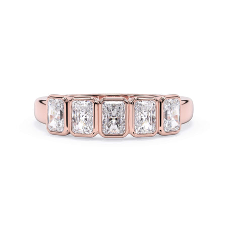 A picture of a five stone diamond wedding ring with radiant cut diamonds that are bezel set in rose gold on a white background with the ring facing forward, lying down.