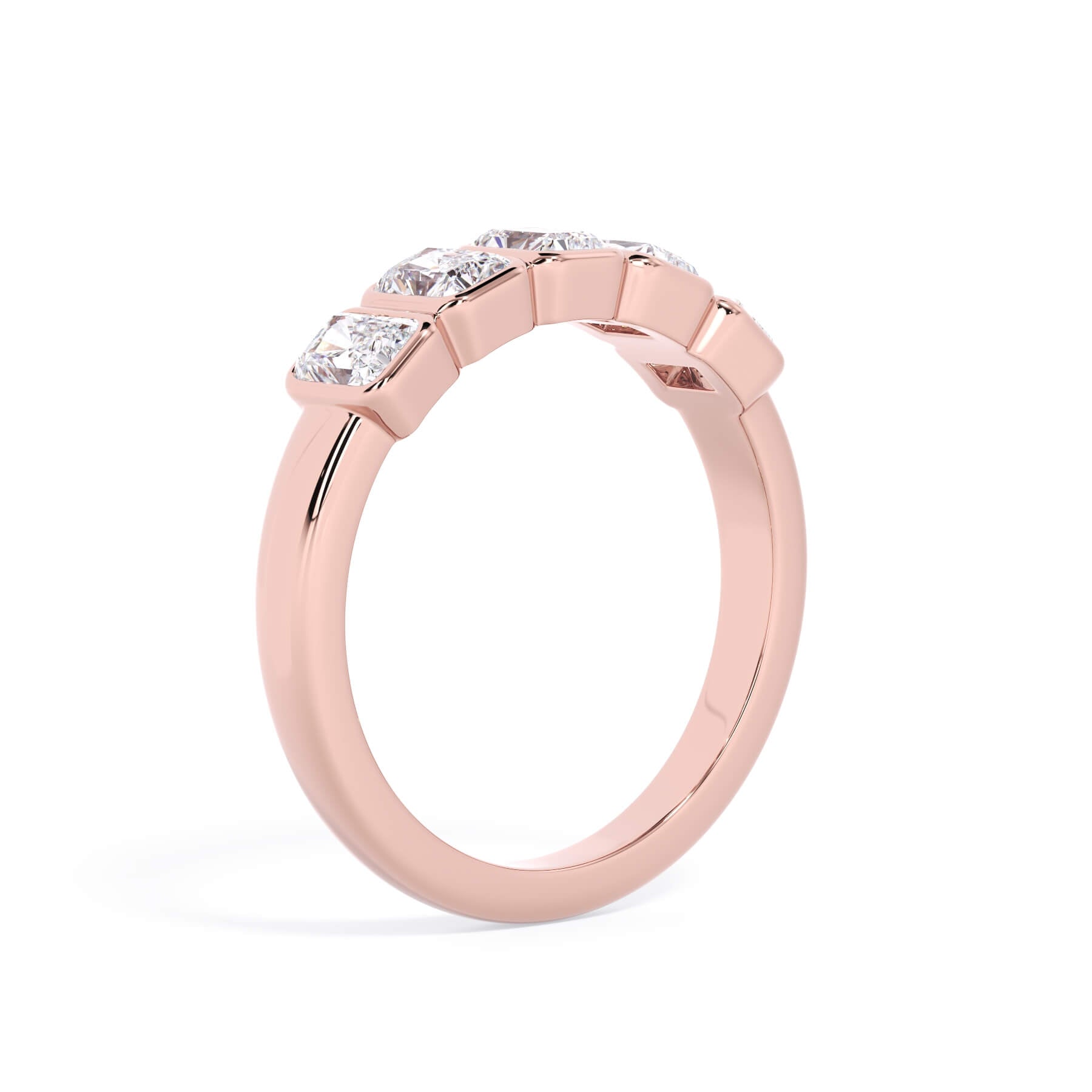 A picture of a five stone diamond wedding ring with radiant cut diamonds that are bezel set in rose gold on a white background with a slightly angled, through the finger view.