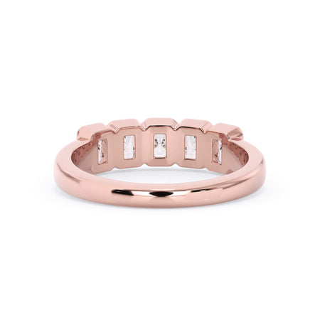 A picture of a five stone diamond wedding ring with radiant cut diamonds that are bezel set in rose gold on a white background with a view of the underside of the ring.
