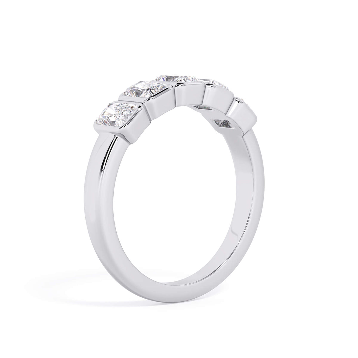 A picture of a five stone diamond wedding ring with radiant cut diamonds that are bezel set in white gold or platinum on a white background with a slightly angled, through the finger view.