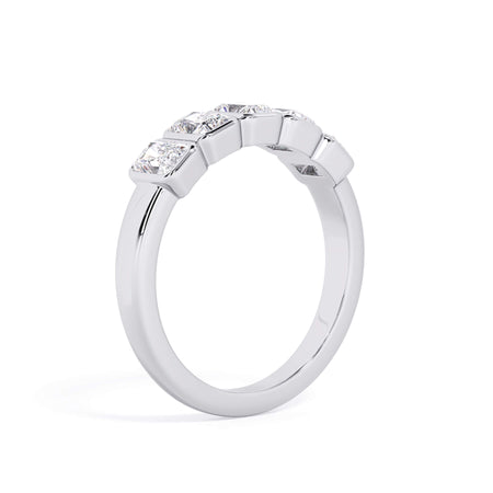 A picture of a five stone diamond wedding ring with radiant cut diamonds that are bezel set in white gold or platinum on a white background with a slightly angled, through the finger view.