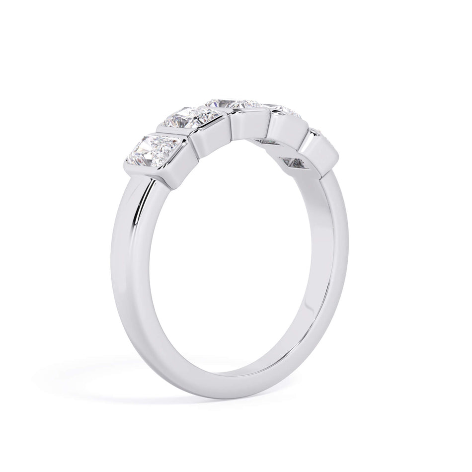 A picture of a five stone diamond wedding ring with radiant cut diamonds that are bezel set in white gold or platinum on a white background with a slightly angled, through the finger view.