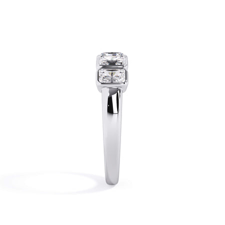 A picture of a five stone diamond wedding ring with radiant cut diamonds that are bezel set in white gold or platinum on a white background with a side profile view.