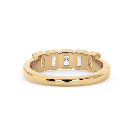 A picture of a five stone diamond wedding ring with radiant cut diamonds that are bezel set in yellow gold on a white background with a view of the underside of the ring.