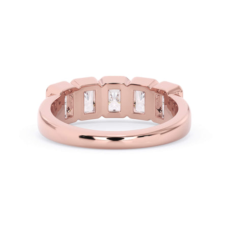 A picture of a five stone diamond wedding ring with radiant cut diamonds that are bezel set in rose gold on a white background with a view of the underside of the ring.
