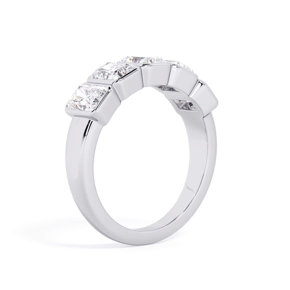 A picture of a five stone diamond wedding ring with radiant cut diamonds that are bezel set in white gold or platinum on a white background with a slightly angled, through the finger view.