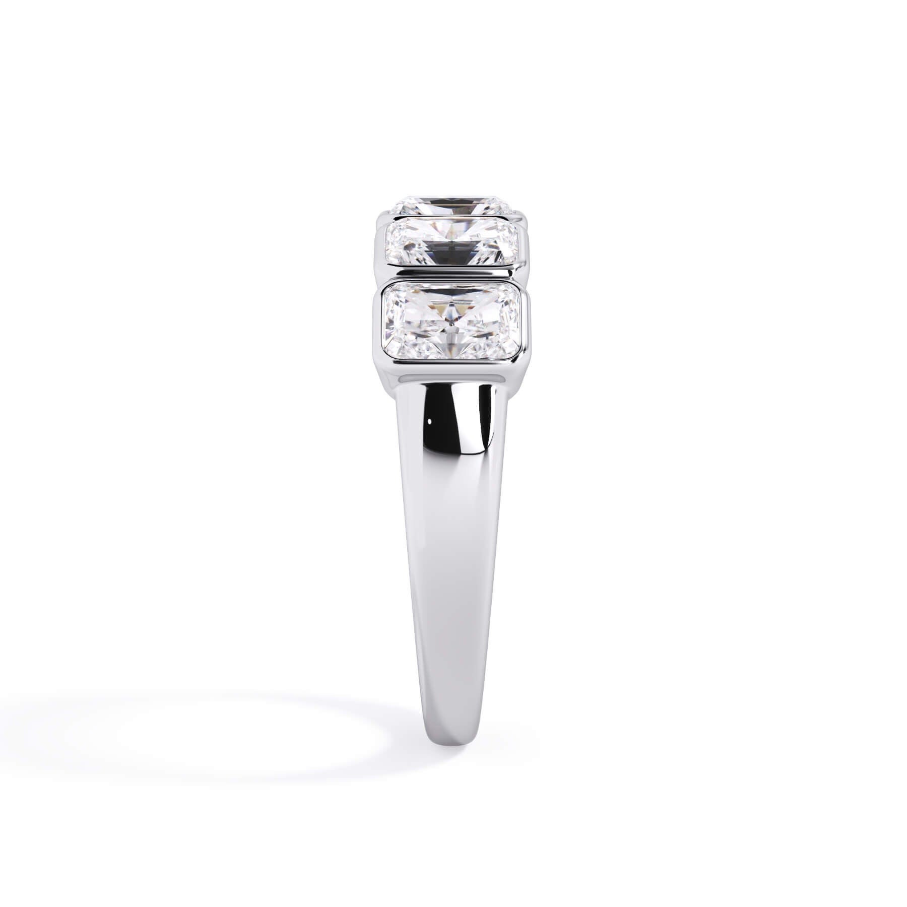 A picture of a five stone diamond wedding ring with radiant cut diamonds that are bezel set in white gold or platinum on a white background with a side profile view.