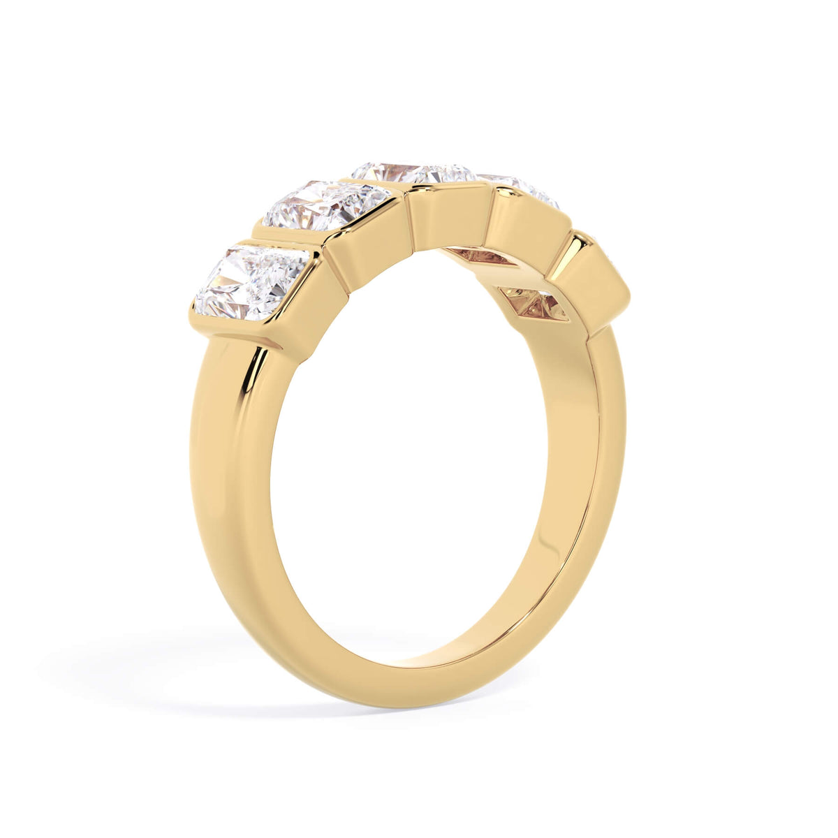 A picture of a five stone diamond wedding ring with radiant cut diamonds that are bezel set in yellow gold on a white background with a slightly angled, through the finger view.