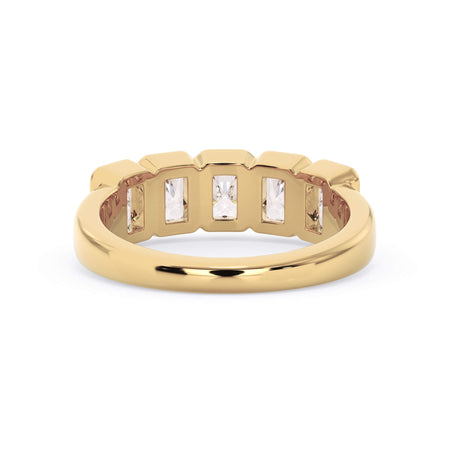 A picture of a five stone diamond wedding ring with radiant cut diamonds that are bezel set in yellow gold on a white background with a view of the underside of the ring.