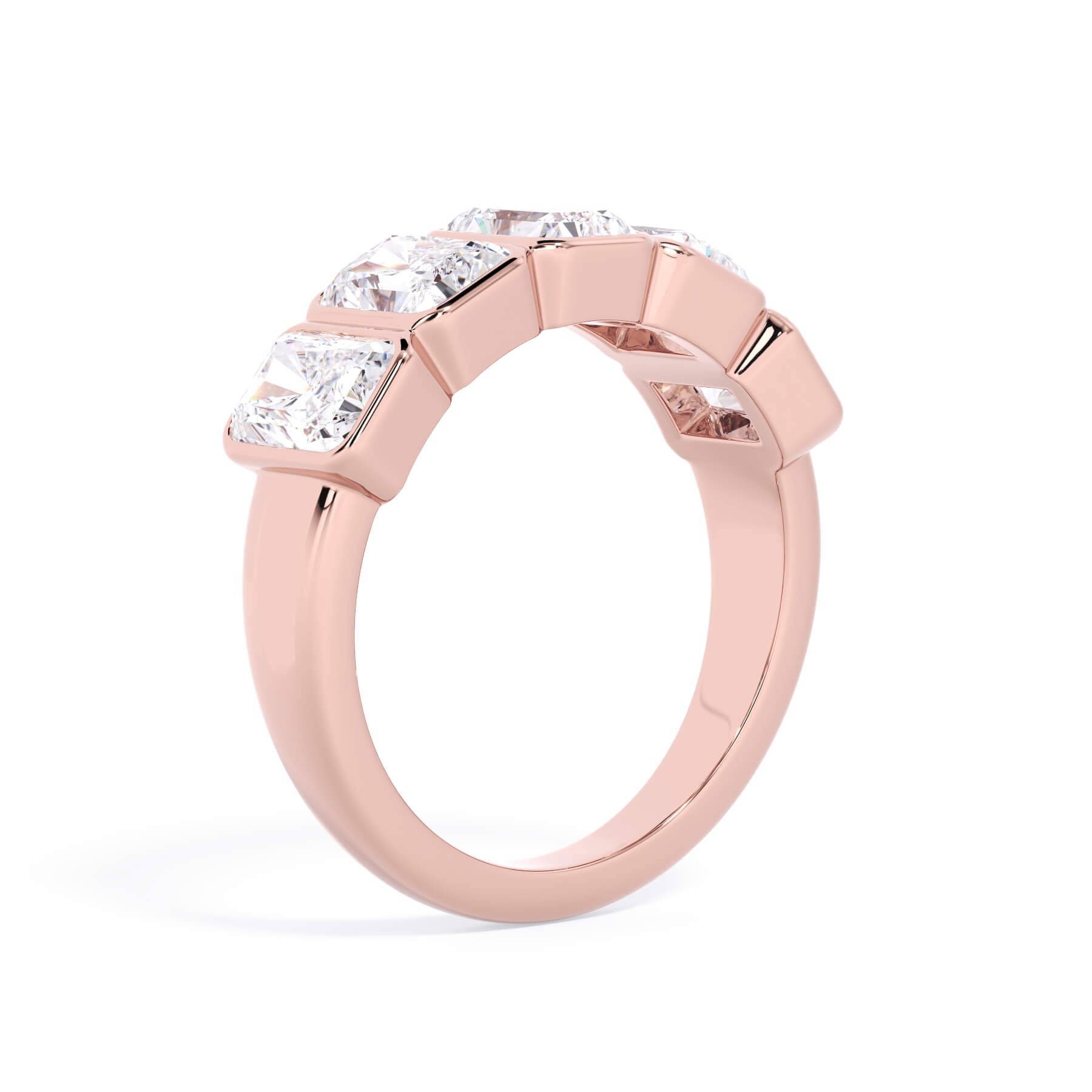 A picture of a five stone diamond wedding ring with radiant cut diamonds that are bezel set in rose gold on a white background with a slightly angled, through the finger view.