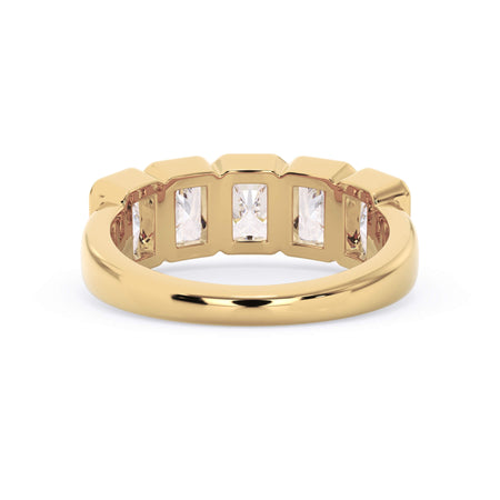 A picture of a five stone diamond wedding ring with radiant cut diamonds that are bezel set in yellow gold on a white background with a view of the underside of the ring.