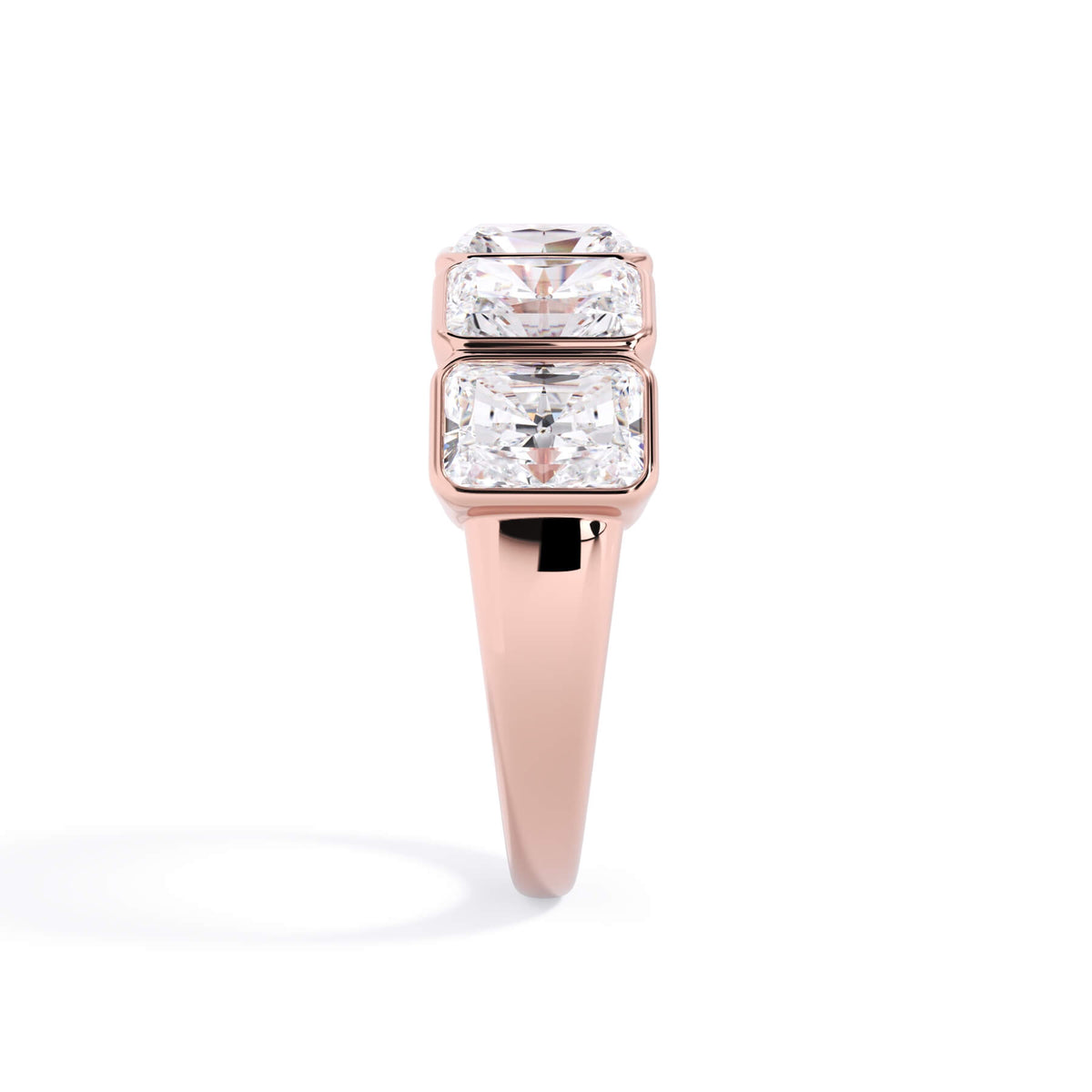 A picture of a five stone diamond wedding ring with radiant cut diamonds that are bezel set in rose gold on a white background with a side profile view.