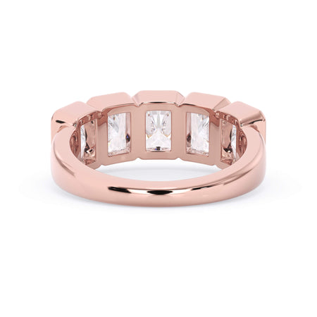 A picture of a five stone diamond wedding ring with radiant cut diamonds that are bezel set in rose gold on a white background with a view of the underside of the ring.