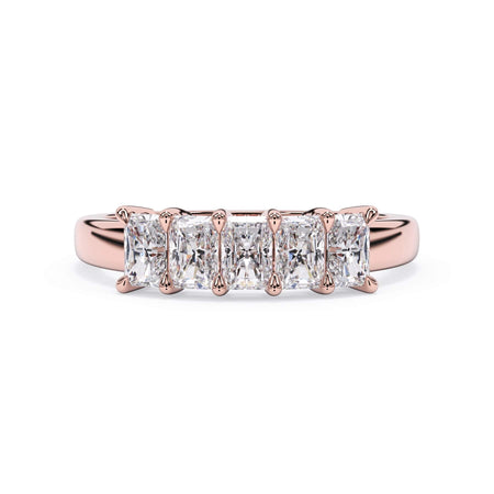 A picture of a five stone diamond wedding ring with radiant cut diamonds that are shared prong set in rose gold on a white background with the ring facing forward, lying down.