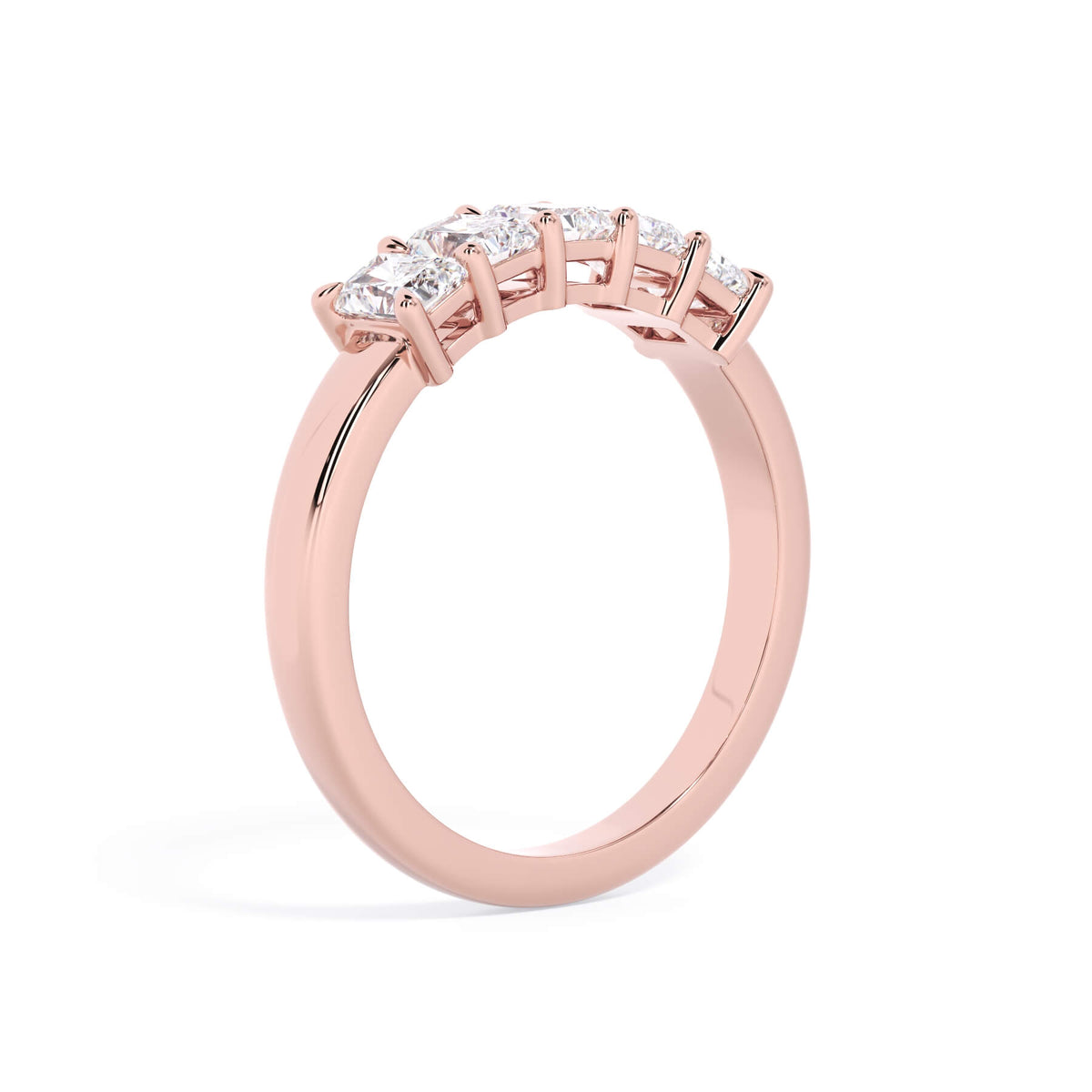 A picture of a five stone diamond wedding ring with radiant cut diamonds that are shared prong set in rose gold on a white background with a slightly angled, through the finger view.