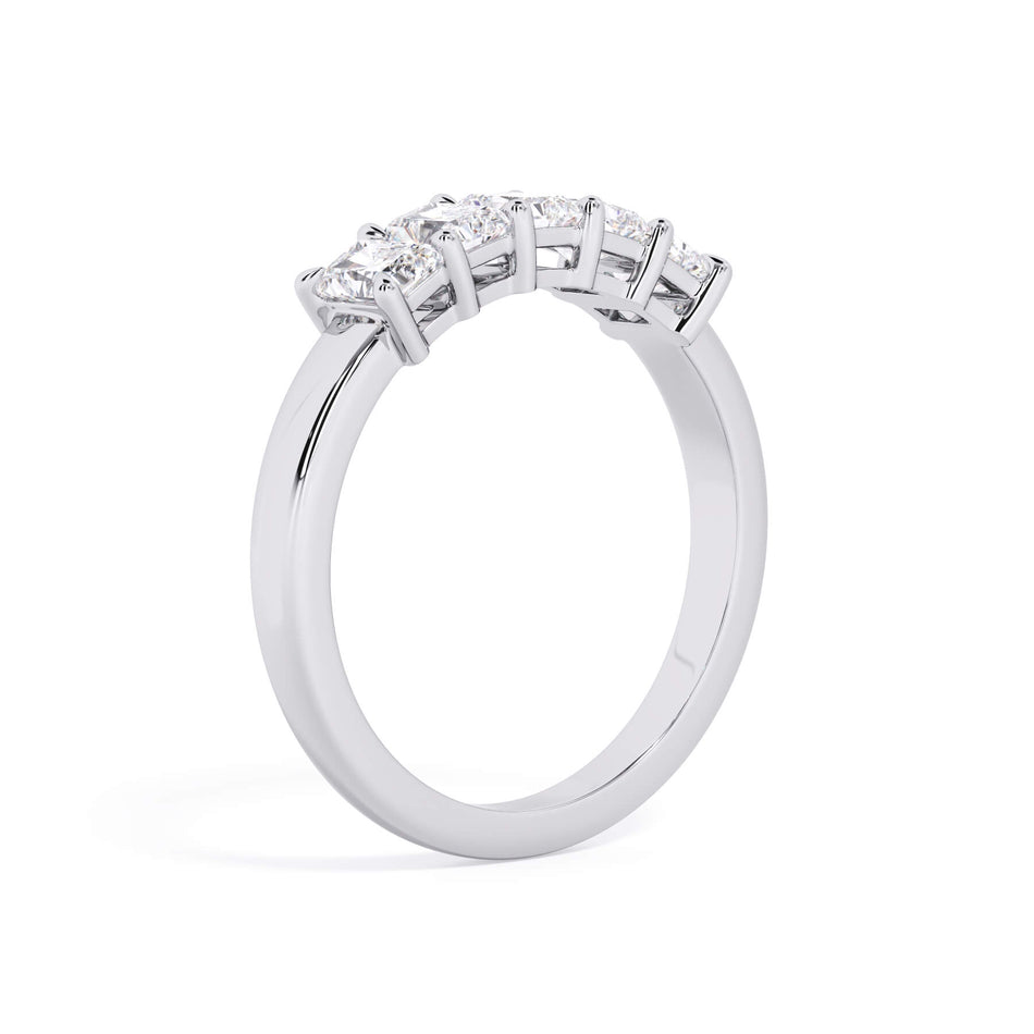 A picture of a five stone diamond wedding ring with radiant cut diamonds that are shared prong set in white gold or platinum on a white background with a slightly angled, through the finger view.