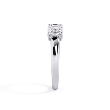 A picture of a five stone diamond wedding ring with radiant cut diamonds that are shared prong set in white gold or platinum on a white background with a side profile view.