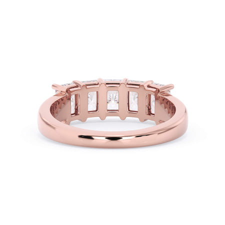 A picture of a five stone diamond wedding ring with radiant cut diamonds that are shared prong set in rose gold on a white background with a view of the underside of the ring.