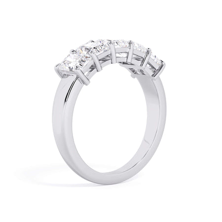 A picture of a five stone diamond wedding ring with radiant cut diamonds that are shared prong set in white gold or platinum on a white background with a slightly angled, through the finger view.