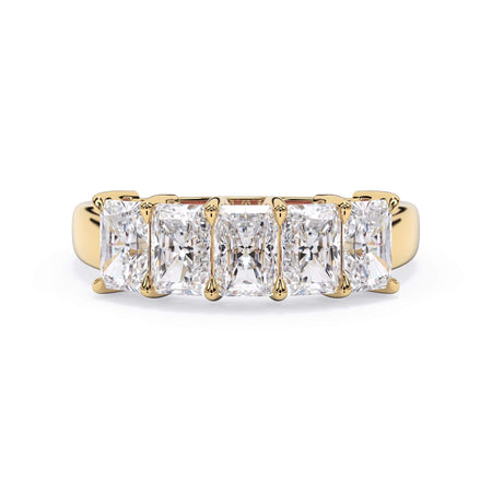 A picture of a five stone diamond wedding ring with radiant cut diamonds that are shared prong set in yellow gold on a white background with the ring facing forward, lying down.