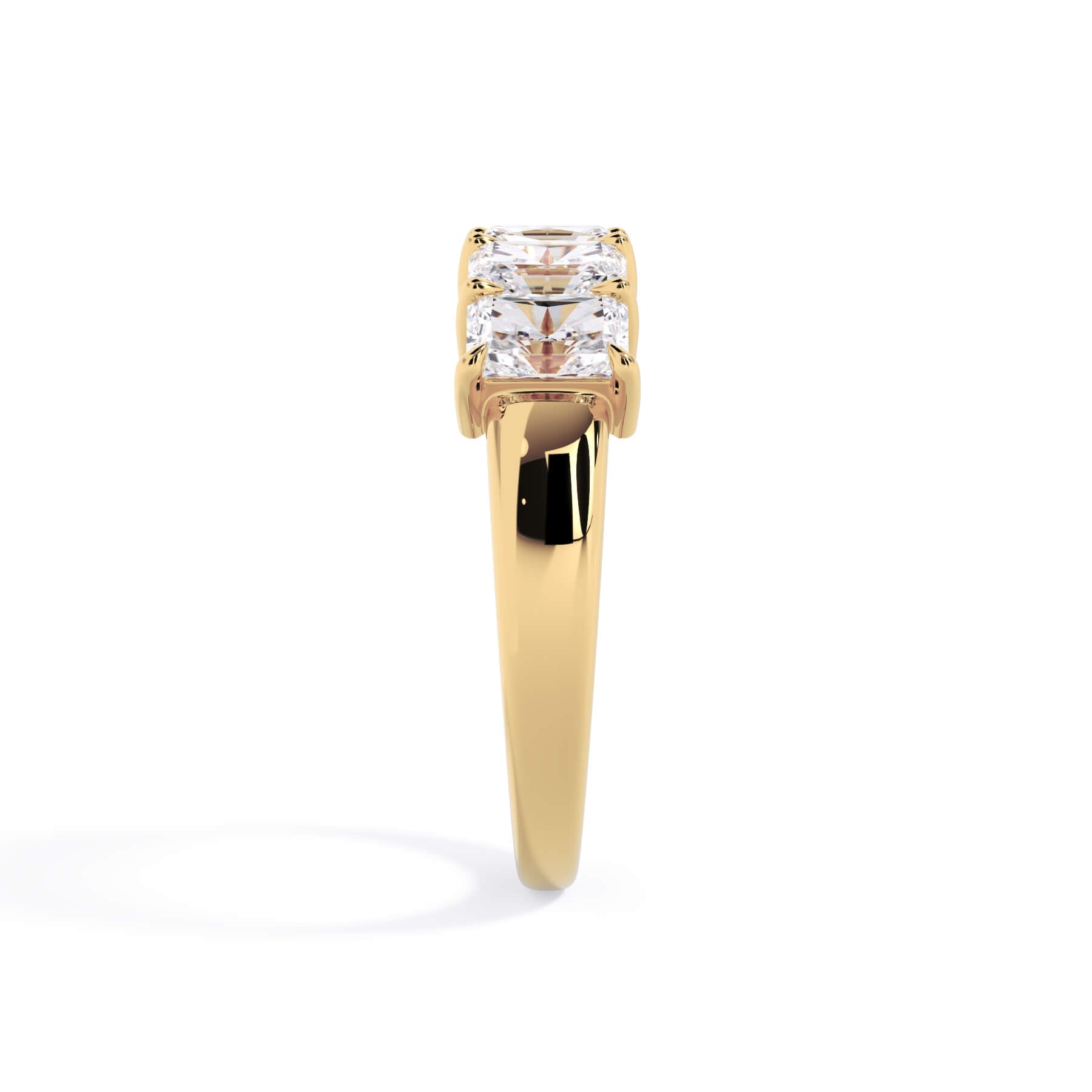 A picture of a five stone diamond wedding ring with radiant cut diamonds that are shared prong set in yellow gold on a white background with a side profile view.
