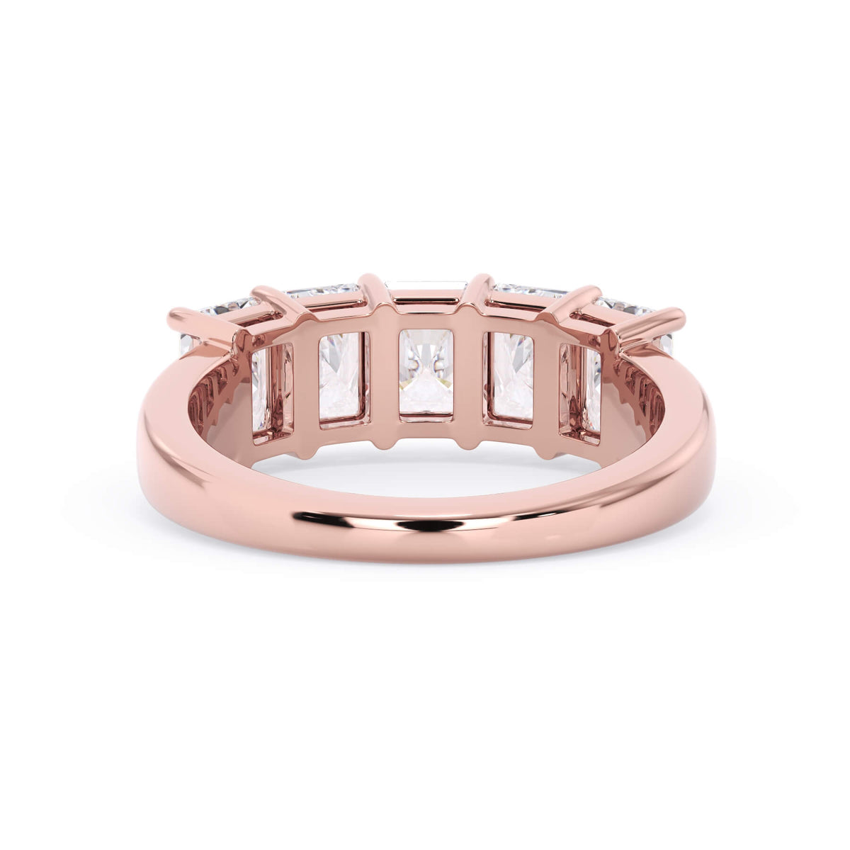 A picture of a five stone diamond wedding ring with radiant cut diamonds that are shared prong set in rose gold on a white background with a view of the underside of the ring.