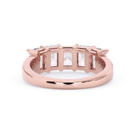 A picture of a five stone diamond wedding ring with radiant cut diamonds that are shared prong set in rose gold on a white background with a view of the underside of the ring.