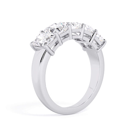A picture of a five stone diamond wedding ring with radiant cut diamonds that are shared prong set in white gold or platinum on a white background with a slightly angled, through the finger view.