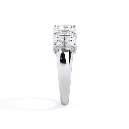 A picture of a five stone diamond wedding ring with radiant cut diamonds that are shared prong set in white gold or platinum on a white background with a side profile view.